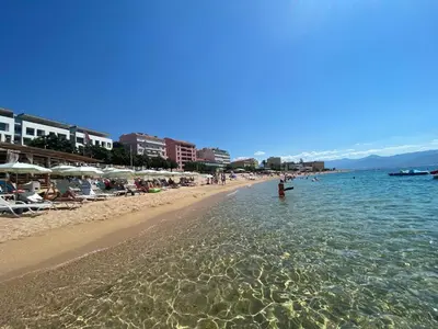 a beach with a person standing in the water at Ajaccio centre bord de mer T3 in Ajaccio