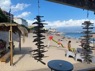 a pole on the beach with people on the beach at Ajaccio centre bord de mer T3 in Ajaccio