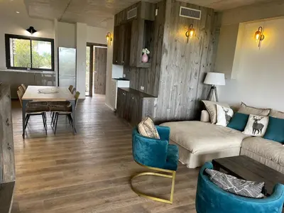 a living room with a couch and a table at A0 Magnifique Appt 6 personnes Lofts de St Lucie in Zonza