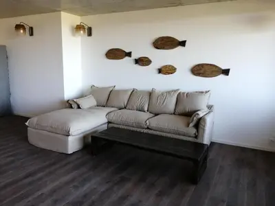 a living room with a couch and a table at A0 Magnifique Appt 6 personnes Lofts de St Lucie in Zonza