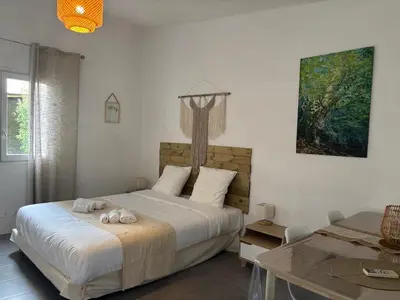 a bedroom with a bed with two towels on it at Gîtes Terra di a Bravona in Linguizzetta
