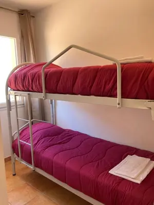 a couple of bunk beds in a room at Punta di mare, appartements bord de mer in Linguizzetta