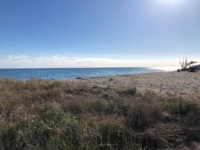 an empty beach with the ocean in the background at 2026 - grand studio avec piscine et plage à 50 m in San-Nicolao