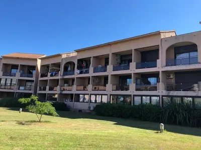 an apartment building with a lawn in front of it at 2026 - grand studio avec piscine et plage à 50 m in San-Nicolao
