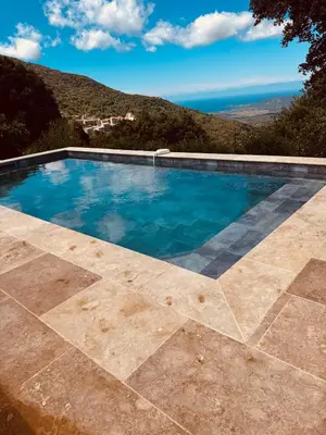 a swimming pool with a view of the ocean at Maison à la campagne. in Sollacaro