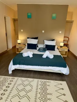 a bedroom with a large bed with two pillows at Maison à la campagne. in Sollacaro