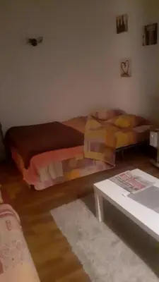 a living room with two beds and a table at Charmant studio in Grosseto-Prugna
