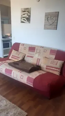 a couch with pillows on it in a living room at Charmant studio in Grosseto-Prugna