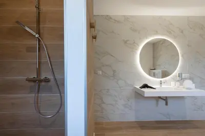 a bathroom with a shower and a sink and a mirror at Villa Cargèse in Cargèse
