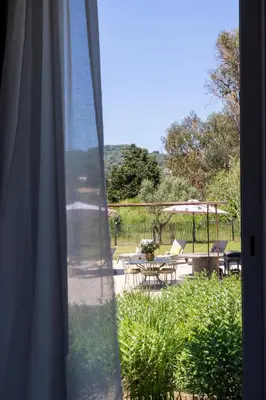 a window view of a patio with a table and chairs at Villa Cargèse in Cargèse