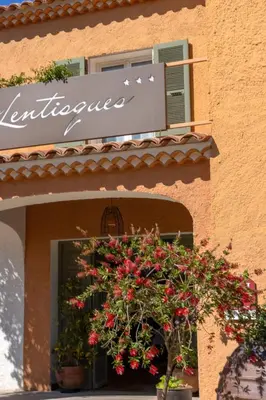 a sign on the side of a building with flowers at Villa Cargèse in Cargèse