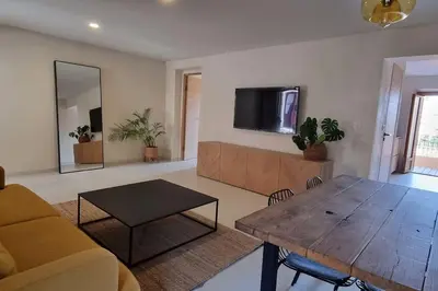 a living room with a couch and a table at Appartement avec terrasse au centre du village in Cargèse