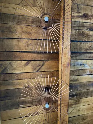 a wooden wall with a wooden spiral staircase with two windows at Villa de charme avec piscine in Sotta