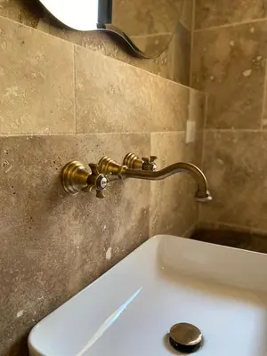 a sink in a bathroom with a gold faucet at Villa de charme avec piscine in Sotta