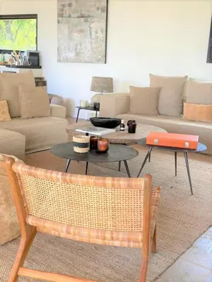 a living room with a couch and a table at Casa Nessa Di Pinarello in Sainte-Lucie de Porto-Vecchio