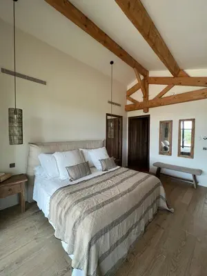a bedroom with a large bed and wooden ceilings at Casa Nessa Di Pinarello in Sainte-Lucie de Porto-Vecchio