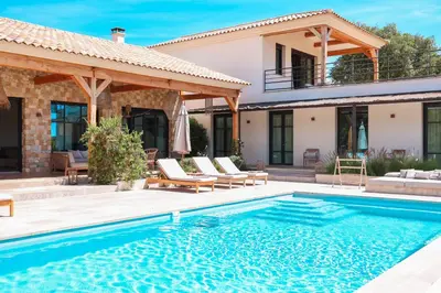 a villa with a swimming pool and a house at Casa Nessa Di Pinarello in Sainte-Lucie de Porto-Vecchio