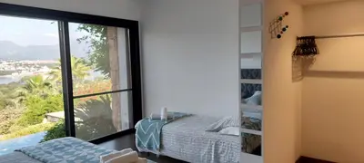 a bedroom with a view of a bed and a window at La baie des anges in Porto-Vecchio