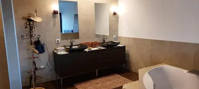 a bathroom with two sinks and a bath tub at La baie des anges in Porto-Vecchio