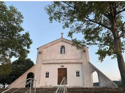 a church with a cross on the top of it at Duplex au Village in Tox