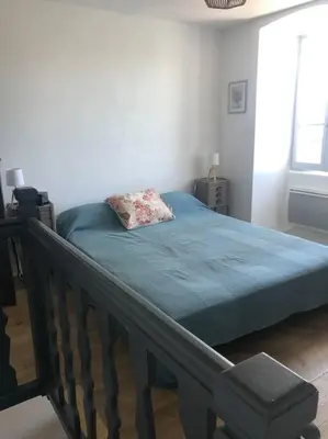 a bedroom with a bed with a pillow on it at Duplex au Village in Tox