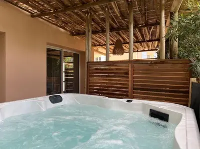 a jacuzzi tub in the middle of a house at T3 avec spa, hyper centre, port in Porto-Vecchio