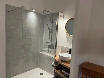 a bathroom with a glass shower with a sink at T3 avec spa, hyper centre, port in Porto-Vecchio