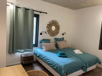 a bedroom with a bed with a mirror on the wall at A1 Magnifique appt 6 personnes Lofts de Ste Lucie in Zonza