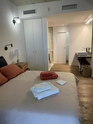 a bedroom with a bed with two towels on it at A1 Magnifique appt 6 personnes Lofts de Ste Lucie in Zonza