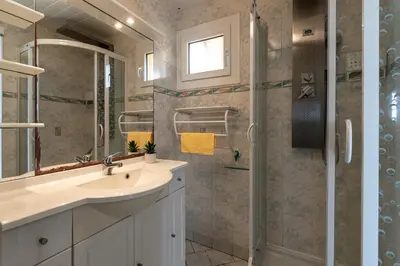 a bathroom with a sink and a shower at Kallistea - Appartement avec vue mer in Porticcio