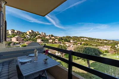 a balcony with a table and a view at Kallistea - Appartement avec vue mer in Porticcio