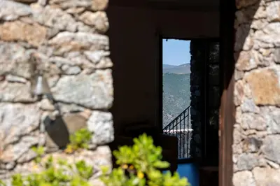 a window in a building with a view of a mountain at Hôtel Case Latine in Lama