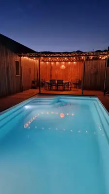 a swimming pool at night with lights on a patio at Casa di Leccia, Superbe Villa à proximité immédiate des plages, piscine privée in Lecci