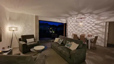 a living room with a couch and chairs and a table at Casa di Leccia, Superbe Villa à proximité immédiate des plages, piscine privée in Lecci