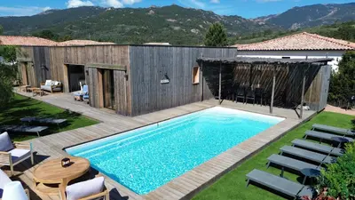 a backyard with a swimming pool and a wooden deck at Casa di Leccia, Superbe Villa à proximité immédiate des plages, piscine privée in Lecci