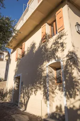 a shadow of a tree on the side of a building at a Casa in Calenzana