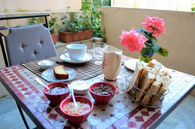a table with food and a vase of flowers on it at a Casa in Calenzana