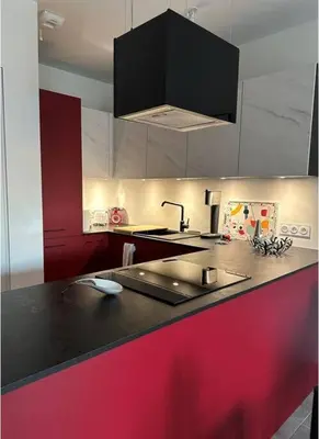 a kitchen with a red and black counter top at Appartement de standing piana in Piana