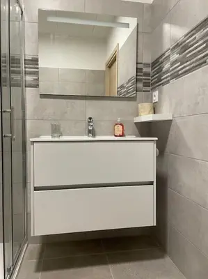 a bathroom with a white sink and a shower at Appartement de standing piana in Piana