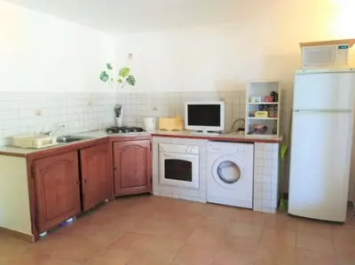 a kitchen with a white refrigerator and a washing machine at GRANDE VILLA TIZZANO A 200 M DE LA PLAGE 18 PERS in Sartène