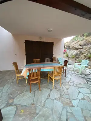 a table and chairs on a stone patio at GRANDE VILLA TIZZANO A 200 M DE LA PLAGE 18 PERS in Sartène