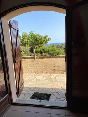 an open door with a view of a patio at GRANDE VILLA TIZZANO A 200 M DE LA PLAGE 18 PERS in Sartène