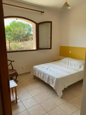 a bedroom with a bed and a large window at GRANDE VILLA TIZZANO A 200 M DE LA PLAGE 18 PERS in Sartène