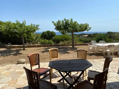 a patio with a table and chairs and a table and chairsktop at GRANDE VILLA TIZZANO A 200 M DE LA PLAGE 18 PERS in Sartène