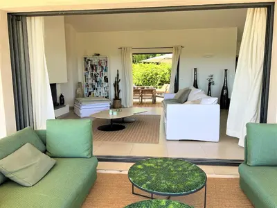 a living room with a couch and a table at Villa A Muredda in Sainte-Lucie de Porto-Vecchio