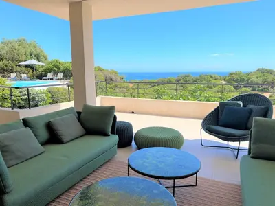 a living room with a couch and two chairs and tables at Villa A Muredda in Sainte-Lucie de Porto-Vecchio