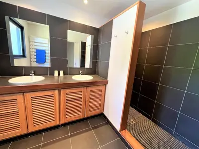 a bathroom with two sinks and a mirror at Villa A Muredda in Sainte-Lucie de Porto-Vecchio