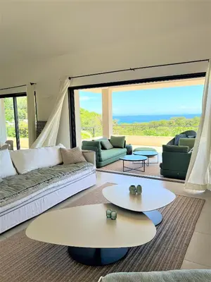 a living room with a couch and a table at Villa A Muredda in Sainte-Lucie de Porto-Vecchio