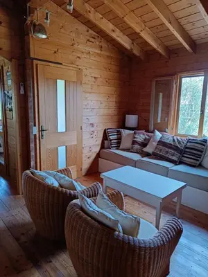 a living room with a couch and chairs and a table at Chalet Maria in Bonifacio