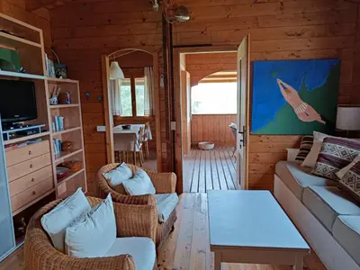 a living room with a couch and chairs and a table at Chalet Maria in Bonifacio